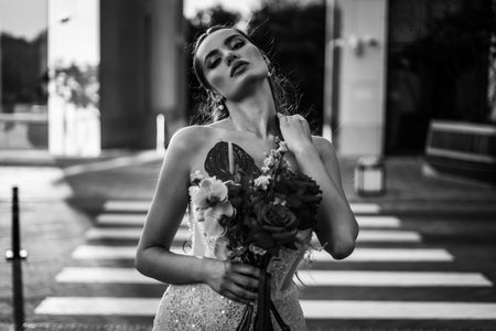 incredibly charming bride poses for a photo in a sophisticated wedding dressの写真素材