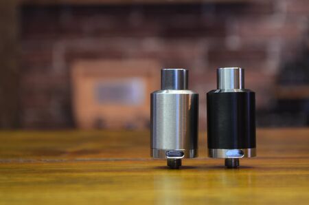 Electronic cigarette on a background of vape shop. E-cigarette for vaping. Popular vape devicesの写真素材