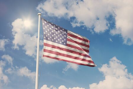 National symbol waving against cloudy, blue sky, sunny dayの写真素材