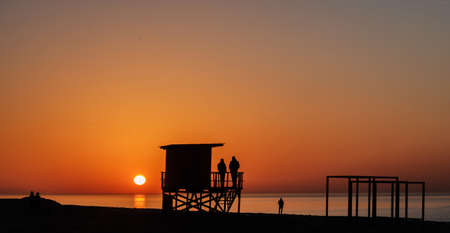 lifeguard tower silhouette on the sunset beachの写真素材