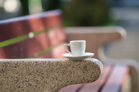 A white coffee cup on the handle of benchの写真素材