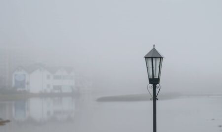 A vintage lamppost behind a blurry lake landscapeの写真素材