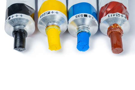 Set of opened oil paint tubes on a white surface