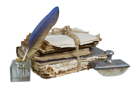 Old books and papers tied with a rope with presse papier and inkwell on a white background, isolatedの写真素材