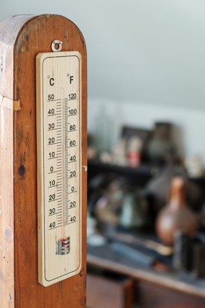 thermometer on the wooden stick, with blurry background 