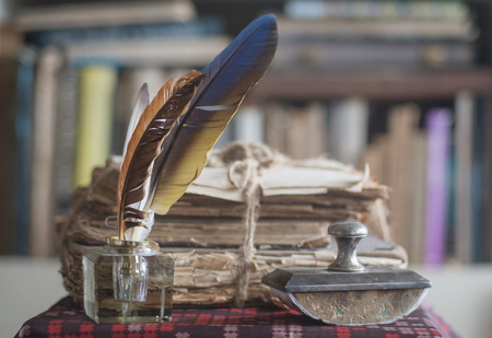 Old books and papers tied with a rope with presse papier and inkwell.の写真素材
