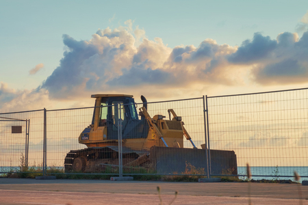 Yellow bulldozer on the sea sideの写真素材