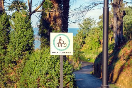 Walk your bike sign in the gardenの写真素材
