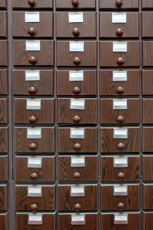 The library's brown wooden catalog file cabinetの写真素材