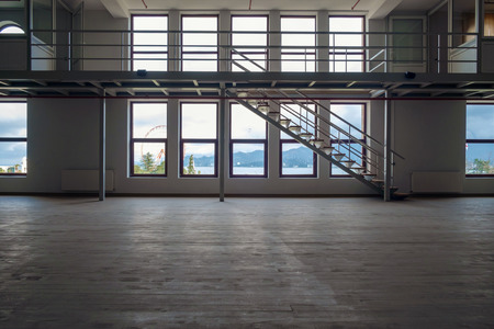 Interior of a large empty room with mezzanineの写真素材