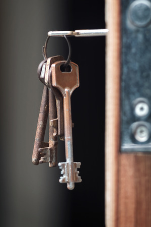 Key in the keyhole, blurry dark background,の写真素材