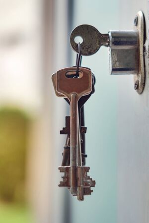 Key in the keyhole, blurry illuminated background,