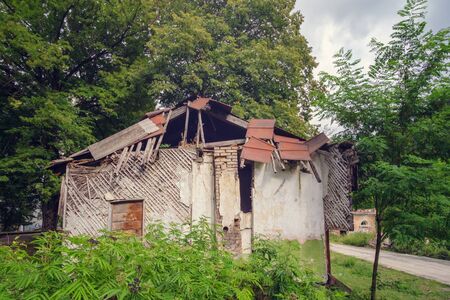 Facade of old abandoned wrecked houseの写真素材