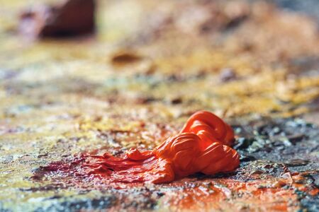 Orange oil paint on the palette, selective focusの写真素材