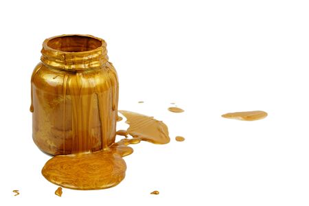 Pouring golden paint on the can, white background isolatedの写真素材