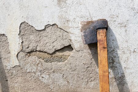 Old hatchet near the grunge wall with drop shadowの写真素材