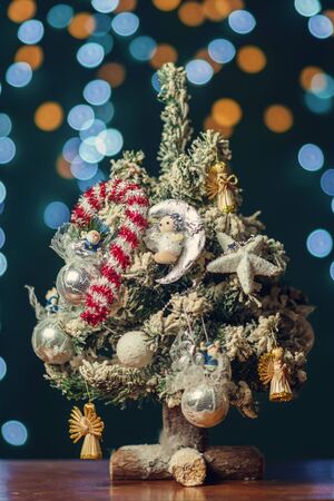 small decorated Christmas Tree with bokeh light vintage backgroundの写真素材