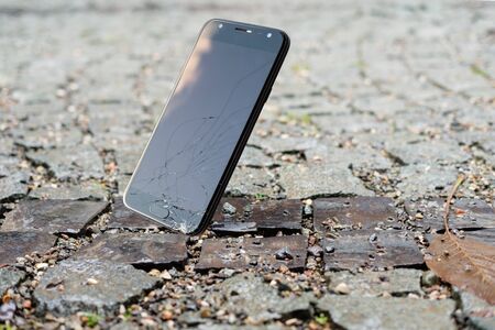 Smartphone falling and crashing on wet ground. accident with smartphone