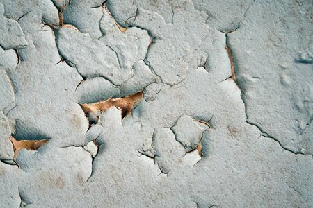 Old cracked wall with moldy peeling blue painting, rusty concrete grunge background or abstract vintage backdropの写真素材
