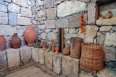 Interior of a traditional Georgian marani (cellar for storing wine in special pitchers) with wine making equipmentの写真素材
