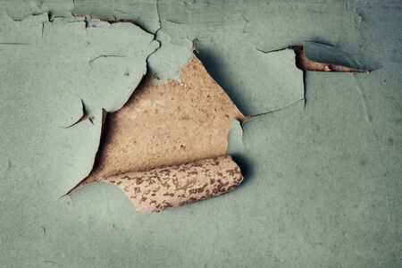 Detail of old cracked wall with moldy peeling painting, rusty grunge textured wall