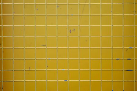 Yellow metal net with blurred yellow background