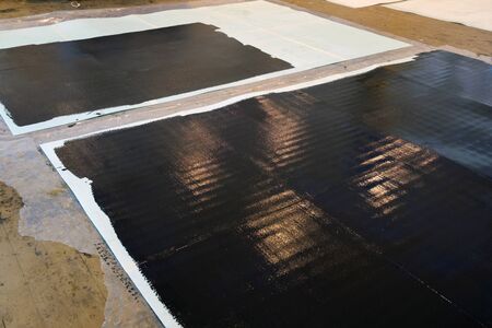 New painted white surface on black paint, painted panels on the wooden floorの写真素材