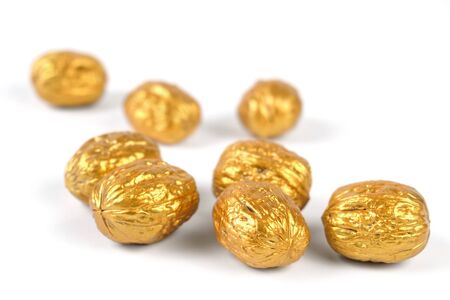 Golden walnuts on a white background, selective focus