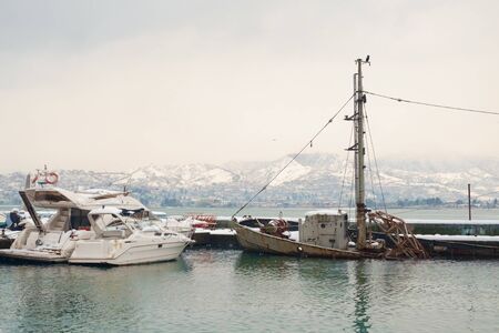Old rusty sunken ship in the sea, winter landscape with sunken boat