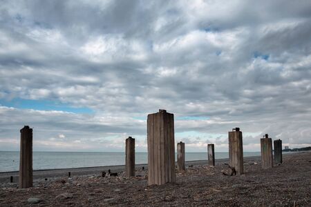 Abandoned industrial building construction site with pillars on the beachの写真素材