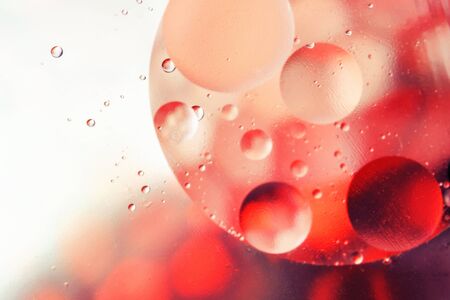 Colorful abstract background with gradient red and white colors, oil drops in water abstract bubbles...