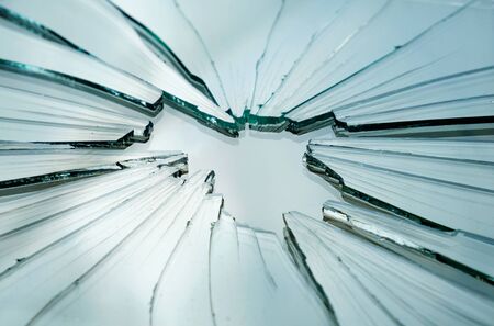 Closeup of broken and cracked glass with hole 
