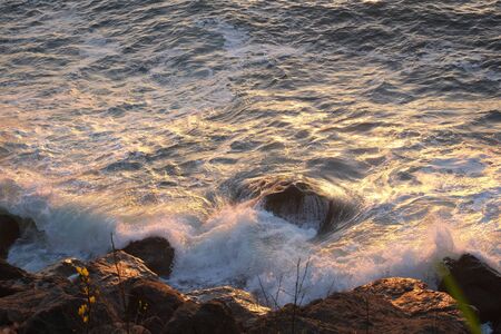 Stormy sea waves crashing against a rocky shore
