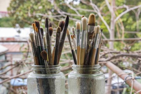 Various professional paint brushes in the transparent jar, selective focusの写真素材