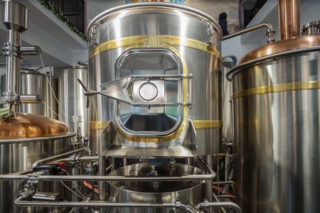 Stainless steel brewing tanks and equipment, iron reservoirs and pipes in modern beer factory....