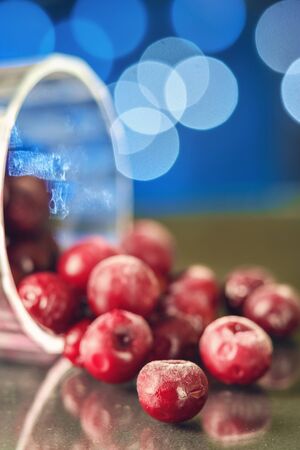 Closeup of the frozen cherry in the glass reflecting on the surface. blurred background selective focus の写真素材