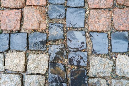 Detail of a vintage traditional wet color stone pavement, top view  の写真素材