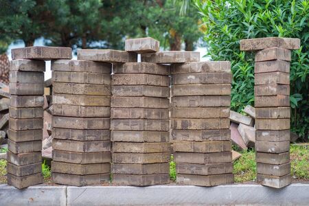 A pile of paving tiles at the park with natural green background