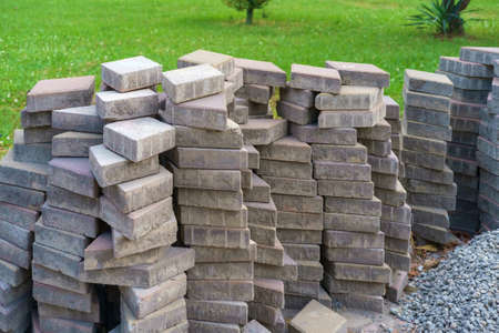 A pile of gray paving tiles on the green meadowの写真素材
