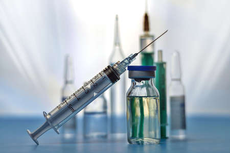 Medicine bottle for injection and syringe with medical vials for vaccination, selective focusの写真素材