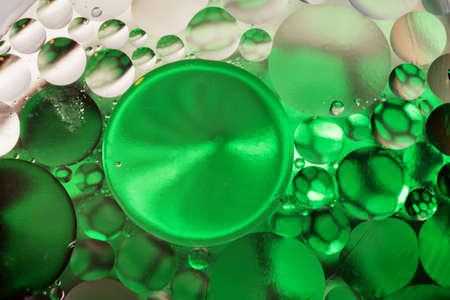 Colorful abstract background with gradient of green and beige colors, oil drops in water abstract bubbles backgroundの写真素材
