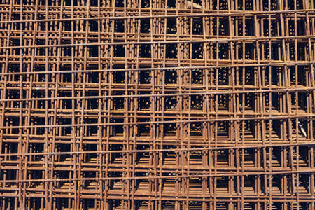 Rusty metal armature net for building construction. Background with metal rebar