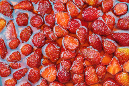 Close up of a dessert with fruit jelly with fresh strawberries, top viewの写真素材