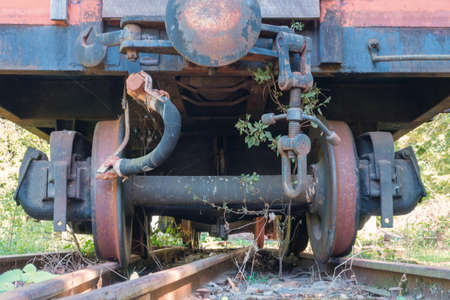 Rusty wheels on a old vintage train wagon standing on a railway