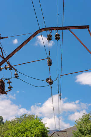Power electricity wires and cables for trains against blue sky with withe clouds