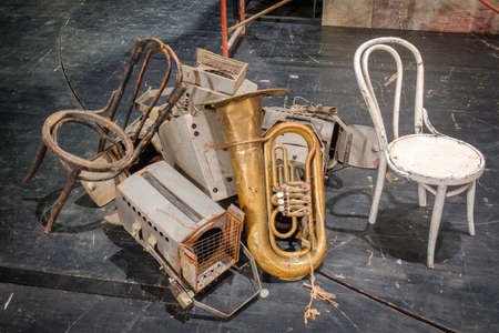 Pile of the theater old decoration requisites, props and equipment on the stageの写真素材