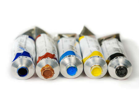 Set of different color oil paint tubes on a white surface