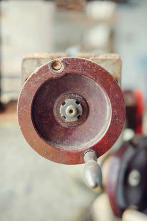 A round handle of an old rusty machine metal mechanism, selective focusの写真素材