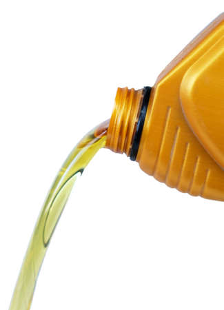 Engine motor oil pouring from a plastic container, isolated on a white backgroundの写真素材