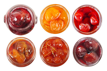 A various jams in a transparent glass jars isolated on a white backgroundの写真素材